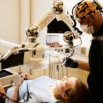 Dr. Bryce Richardson performing dental implant surgery with Yomi robotic system at Boulder dental office