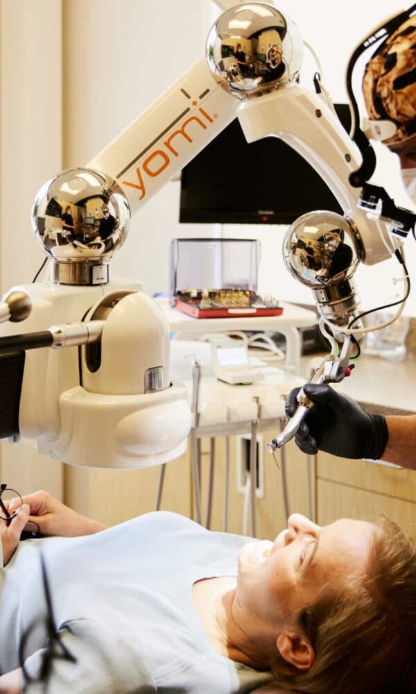 Dr. Bryce Richardson performing dental implant surgery with Yomi robotic system at Boulder dental office