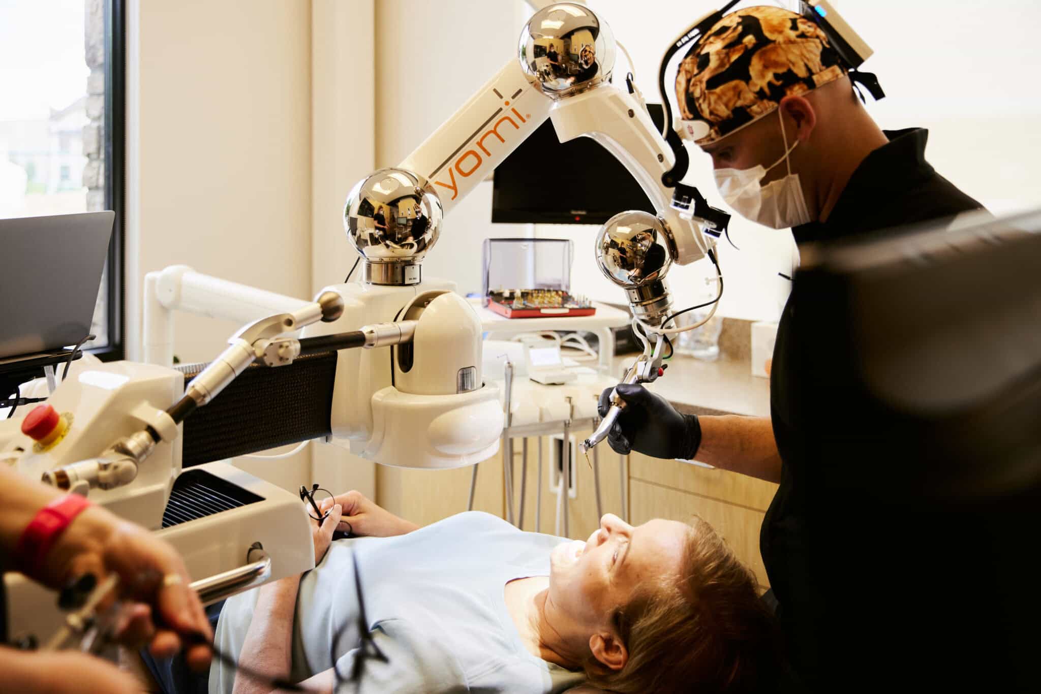 Dr. Bryce Richardson performing dental implant surgery with Yomi robotic system at Boulder dental office